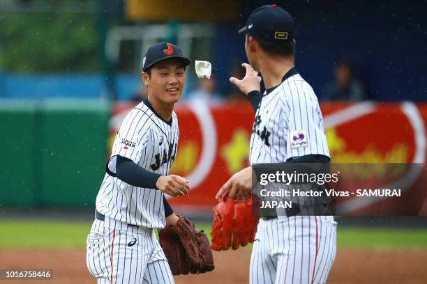 Ikinasuke Fujimori of Japan throws a pillow to Sohi Kiyota of Japan during the WBSC U-15 World Cup Group B match between Australia and Japan at...