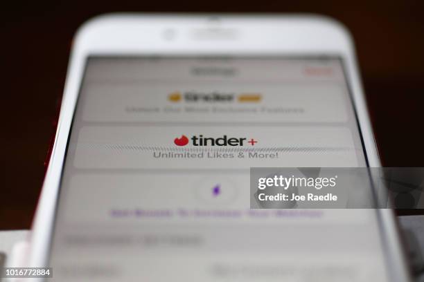 In this photo illustration, the dating app Tinder is seen on the screen of an iPhone on August 14, 2018 in Miami, Florida. The co-founders of Tinder...