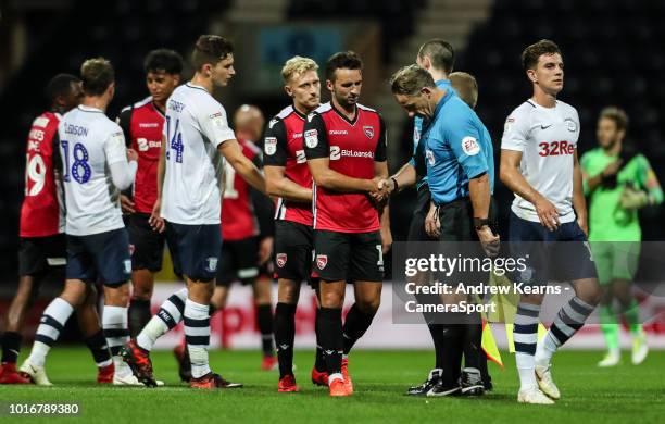 Officials and players from both teams shake hands at the end of the match during the Carabao Cup First Round match between Preston North End and...