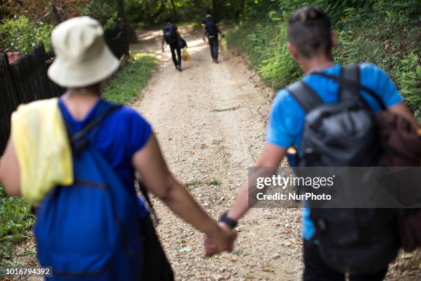 Refugee holds his wife's hand during reaching Croatian border near Velika Kladusa, Bosnia and Herzegovina on August 13, 2018.