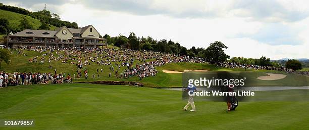 Graeme McDowell of Northern Ireland selects a club for his third shot into 18th green during the final round of the Celtic Manor Wales Open on The...