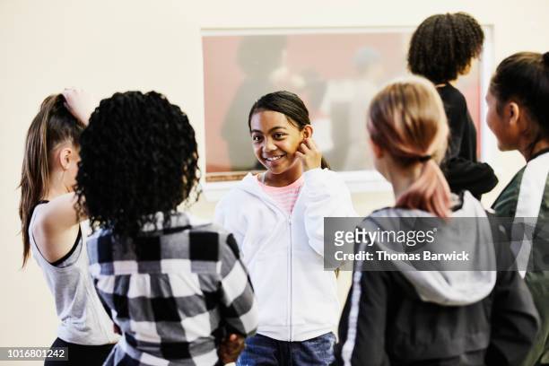 smiling young hip hop dance students in discussion during break during dance class - 13 reasons why stock-fotos und bilder