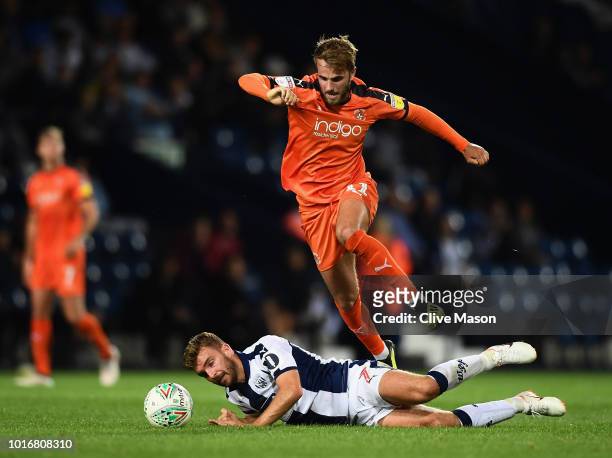 James Morrison of West Bromwich Albion is challenged by Andrew Shinnie of Luton Town during the Carabao Cup First Round match between West Bromwich...