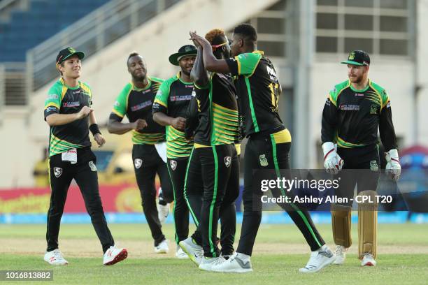 In this handout image provided by CPL T20, Jamaica Tallawahs celebrate the wicket of David Warner during the Hero Caribbean Premier League match...
