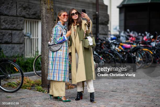 Janka Polliani wearing multi color checked coat, Balenciaga belt bag, high waist wide leg pants and Darja Barannik wearing beige trench coat with...