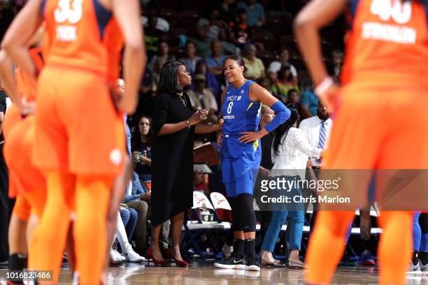 Assistant Coach Taj McWilliams-Franklin of the Dallas Wings speaks with Elizabeth Cambage of the Dallas Wings during the game against the Connecticut...
