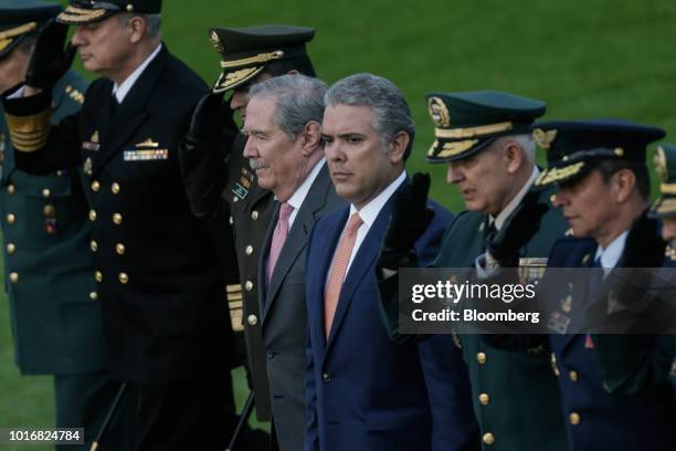 Ivan Duque, Colombia's president, center right, and Guillermo Botero, Colombia's defense minister, center left, arrive for a military ceremony at the...