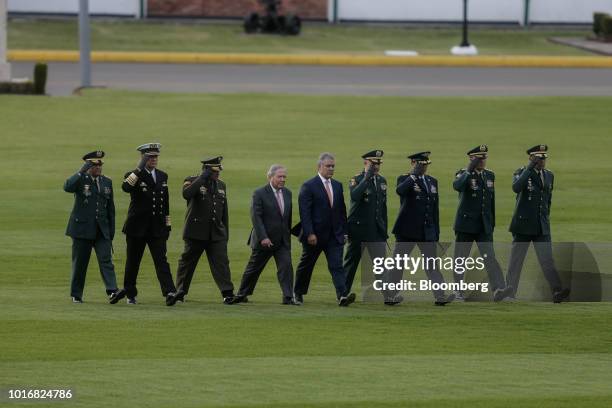 Ivan Duque, Colombia's president, center right, and Guillermo Botero, Colombia's defense minister, center left, arrive for a military ceremony at the...