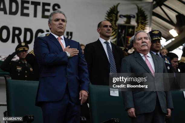 Ivan Duque, Colombia's president, left, and Guillermo Botero, Colombia's defense minister, right, attend a military ceremony at the Jose Maria...