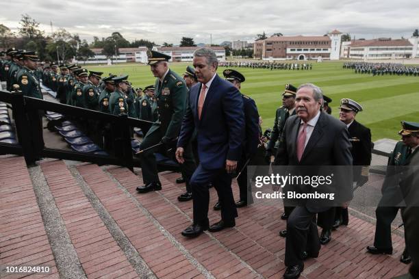 Ivan Duque, Colombia's president, center, and Guillermo Botero, Colombia's defense minister, right, arrive for a military ceremony at the Jose Maria...