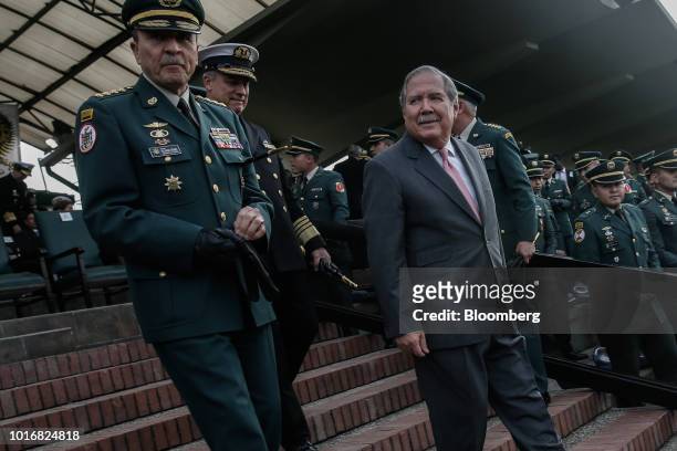 Guillermo Botero, Colombia's defense minister, right, leaves after a military ceremony at the Jose Maria Cordova Military School of Cadets in Bogota,...