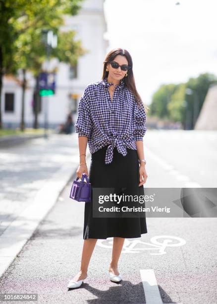 Funda Christophersen wearing checked button skirt, black midi skirt, purple bag seen outside Anne Karine Thorbjornsen during Oslo Runway SS19 on...