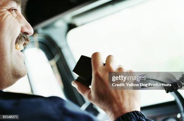 truck driver talking on cb, close-up - cabina de condutor imagens e fotografias de stock