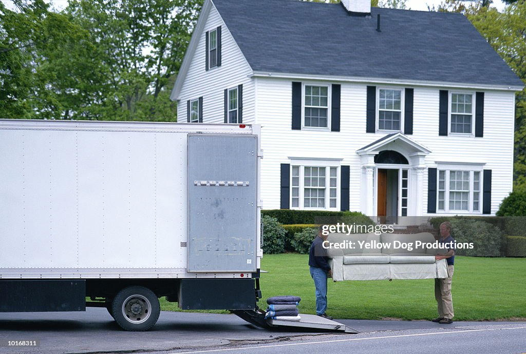 MOVING MEN UNLOAD FURNITURE FROM TRUCK
