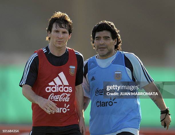 Argentina's football team coach Diego Maradona speaks with forward Lionel Messi during a training session in Ezeiza, Buenos Aires on March 24, 2009....