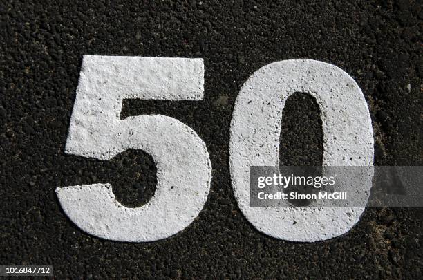 parking spot number 50 stencilled in paint on the asphalt in melbourne, victoria, australia - number 50 imagens e fotografias de stock