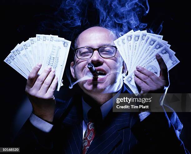 businessman with money, smoking cigar - 欲張り ストックフォトと画像