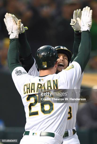 Jed Lowrie and Matt Chapman of the Oakland Athletics celebrates after Lowrie hit a two-run home run against the Seattle Mariners in the bottom of the...