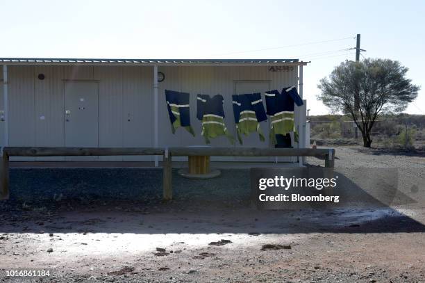 High visibility clothing hangs from a laundry line outside a miners' cabin at the Granny Smith gold mine , operated by Gold Fields Ltd., outside of...