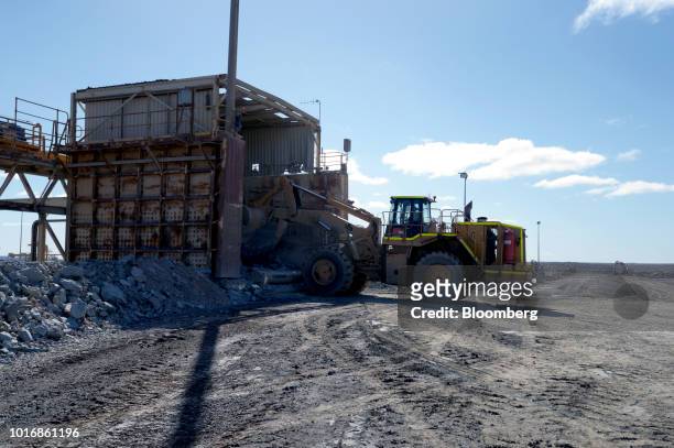 Front loader deposits ore into an initial crushing station on the run-of-mine pad at the Granny Smith gold mine , operated by Gold Fields Ltd.,...