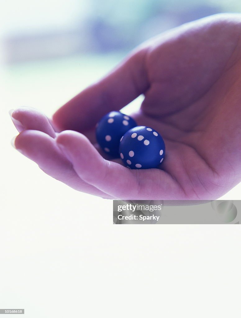 HAND HOLDING DICE