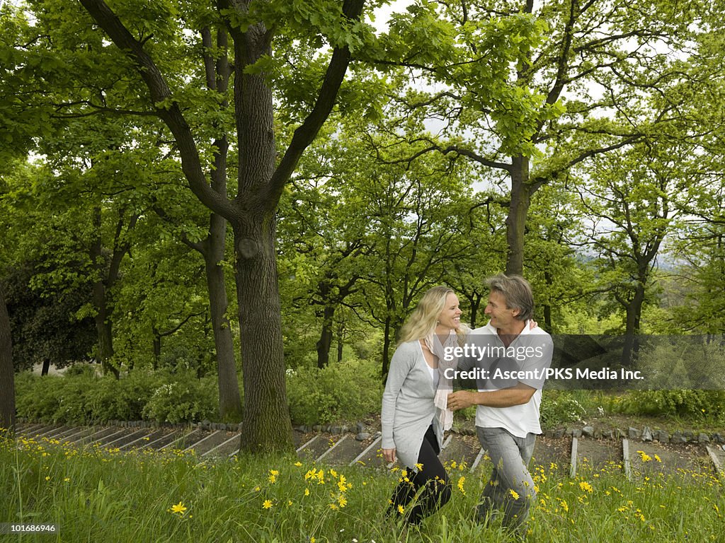 Couple walk through spring flowers above walkway