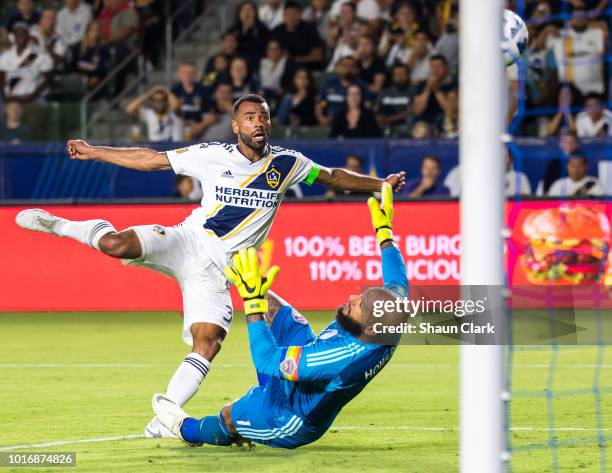 Ashley Cole of Los Angeles Galaxy scores a goal on Tim Howard of Colorado Rapidsduring the Los Angeles Galaxy's MLS match against Colorado Rapids at...