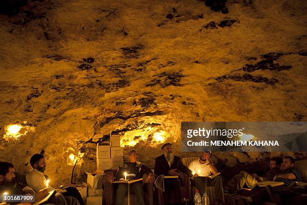 Kabbalist Rabi Uri Revach sits among his students during overnight Kabbalah studies inside a Jerusalem mountain cave near the village of Beit Meir on...