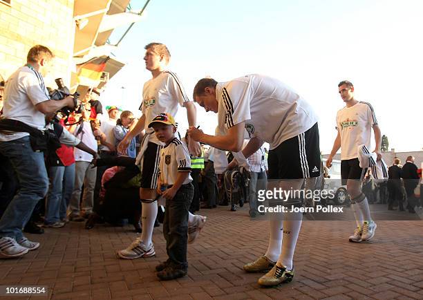Per Mertesacker of Germany gives an autograph to a child prior to training session at Super stadium on June 7, 2010 in Atteridgesville, South Africa.