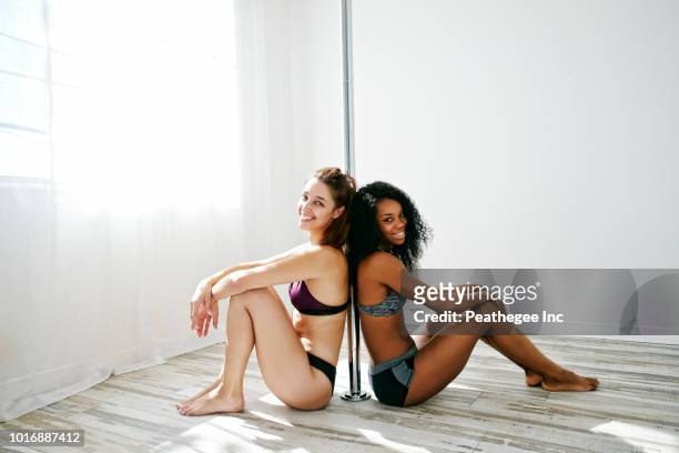 women exercising on pole - pole dance fotografías e imágenes de stock