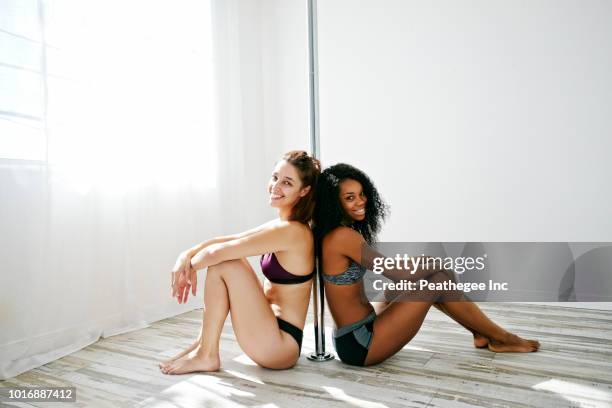 women exercising on pole - pole dancing stock pictures, royalty-free photos & images