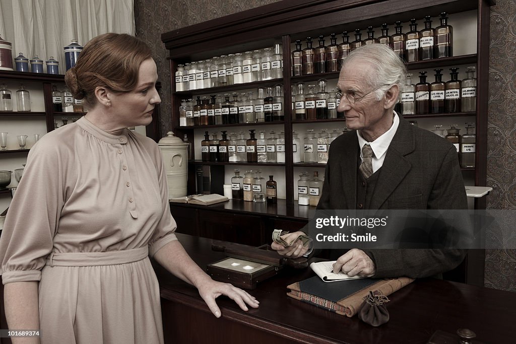 Pharmacist receiving payment for medicines