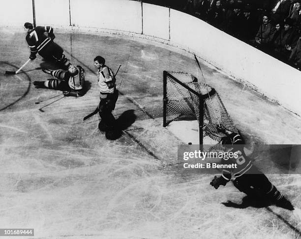 Joe Klukay and Max Bentley of the Toronto Maple Leafs celebrate as Bentley scored on goalie Frank Brimsek of the Boston Bruins during an NHL game...