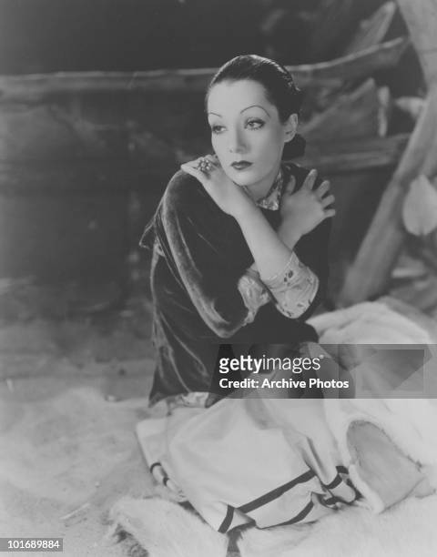 Promotional portrait of Mexican actress Lupe Velez , nicknamed the 'Mexican Spitfire,' as she poses with her arms crossed over her shoulders, early...
