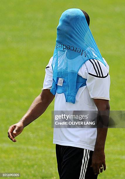 German forward Cacau has his shirt over his face during a training session in Appiano, near the north Italian city of Bolzano May 26, 2010. The...