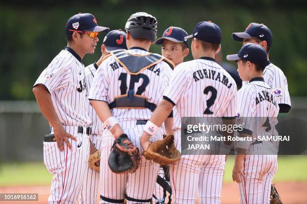 Manager, Toshihisa Nishi of Japan speaks to his players in the top of the first inning during the BFA U-12 Asian Championship Group A match between...