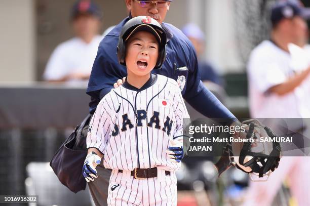 Kenta Makihara of Japan reacts after being struck by the ball in the bottom of the first inning during the BFA U-12 Asian Championship Group A match...