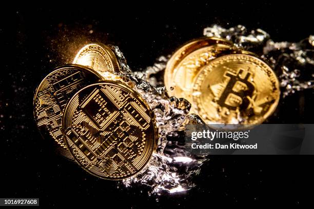 In this photo illustration a visual representation of the digital currency Bitcoin sinks into water on August 15, 2018 in London, England. Most...