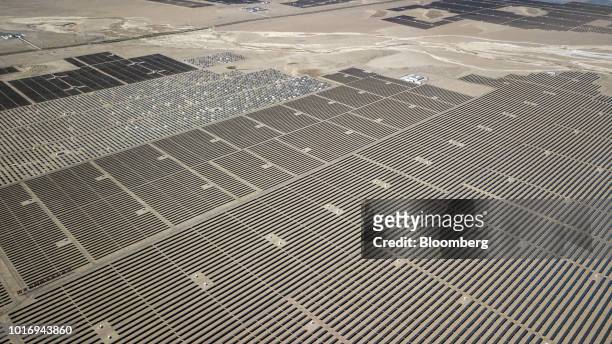 Photovoltaic panels stand at a solar power station operated by Huanghe Hydropower Development Co., a unit of State Power Investment Corp., at the...
