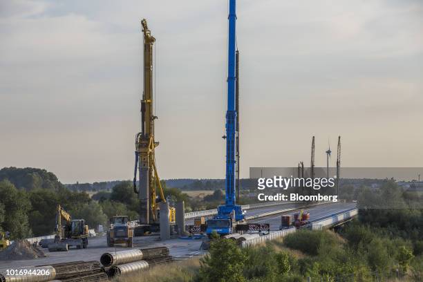 Pile drivers and other construction machinery stand during ongoing repair work on the A20 Autobahn near Tribsees, Germany, on Wednesday, Aug. 1,...