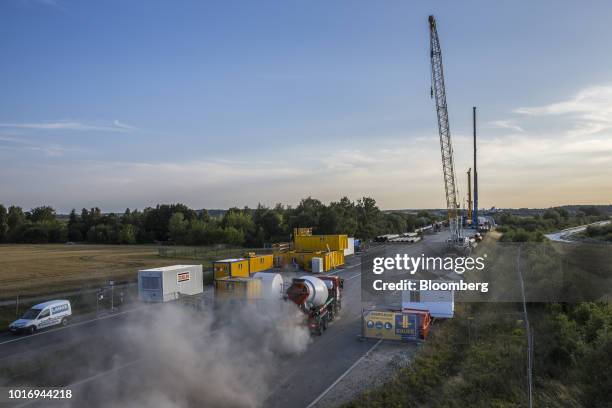 Dust rises as a cement mixer truck travels on the road during ongoing repair work on the A20 Autobahn near Tribsees, Germany, on Wednesday, Aug. 1,...