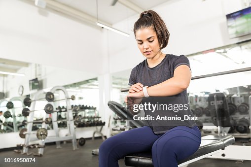 Sporty Female Checking Fitness Activity On Smart Watch In Gym Sporty Female Checking Fitness Activity On Smart Watch In Gym