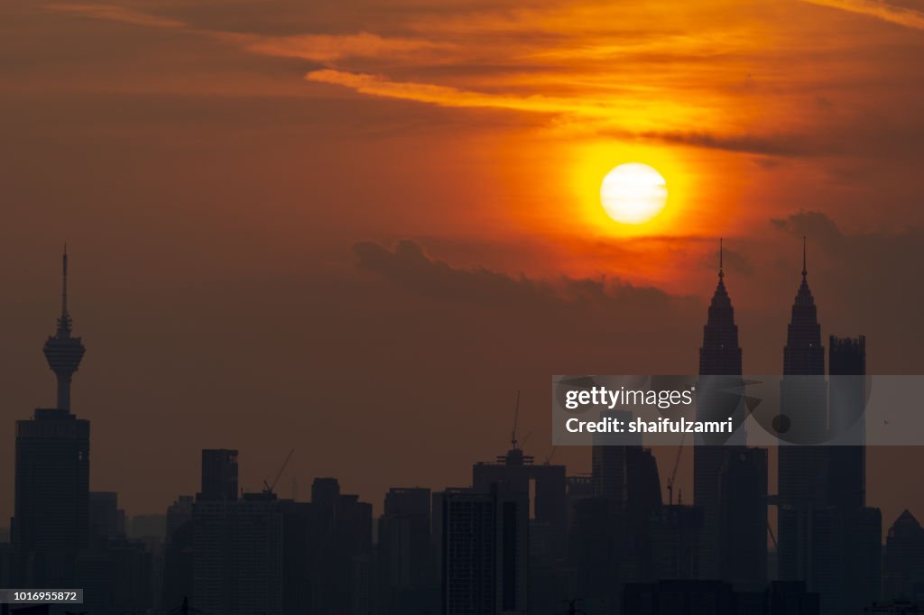 Majestic sunset over Twin Towers and surrounded buildings in downtown Kuala Lumpur, Malaysia.