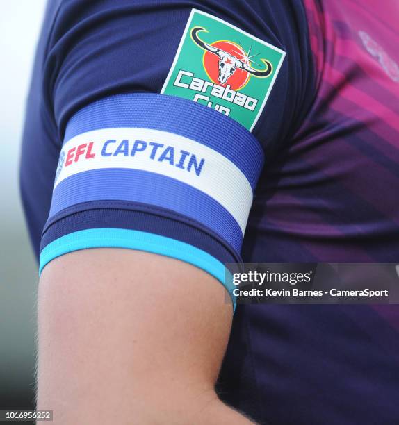 Close up detail of the Carabao Cup badge and captain's armband on Aston Villa's Tommy Elphick's shirt during the Sky Bet League Two match between...