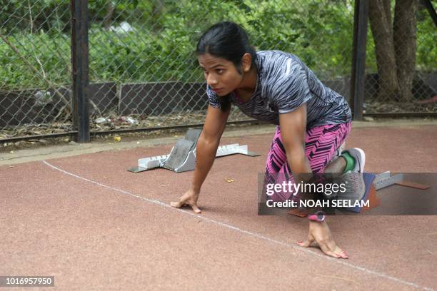 In this photograph taken on August 8 Indian sprinter Dutee Chand practices her start during a training session at the GMC Balayogi Athletic Stadium...