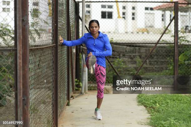 In this photograph taken on August 8 Indian sprinter Dutee Chand warms up during a training session at the GMC Balayogi Athletic Stadium in...