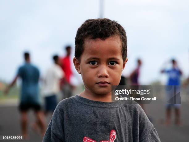 Tao Dao poses for a photograph on the airport runway as a volleyball game is underway on August 15, 2018 in Funafuti, Tuvalu. The small South Pacific...