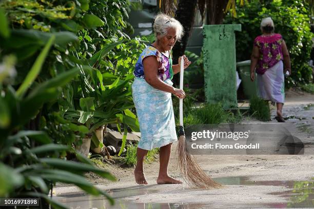 Woman sweeps outside her house on August 15, 2018 in Funafuti, Tuvalu. The main jobs undertaken in the morning are cleaning the front of the property...