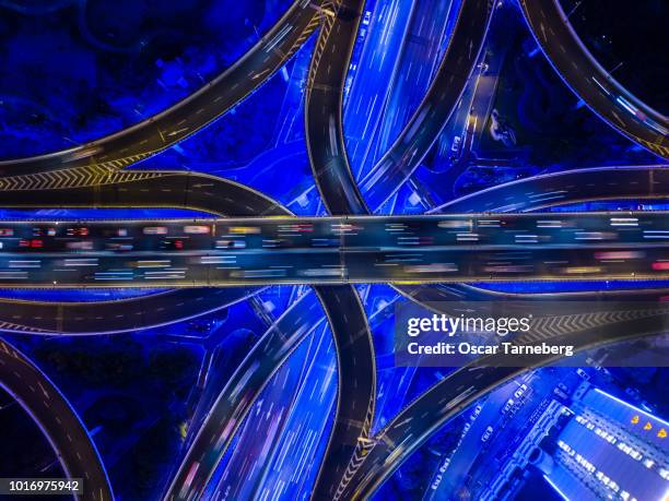 aerial view of neon highway intersection shanghai - overpass stock pictures, royalty-free photos & images