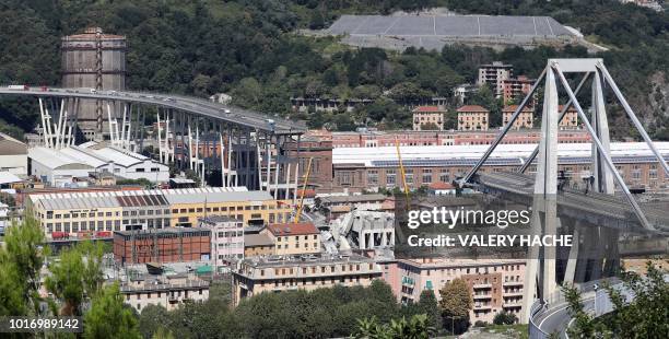 This general view taken on August 15 shows abandoned vehicles on the Morandi motorway bridge the day after a section collapsed in the north-western...